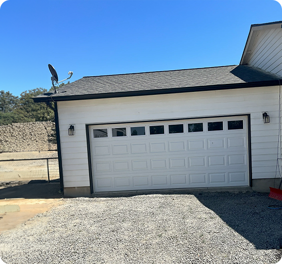 A white garage door with black trim and windows.