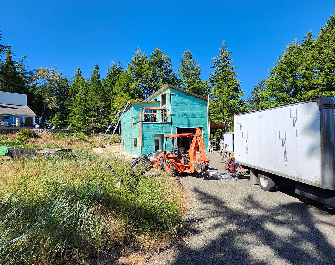 A house under construction with a loader.