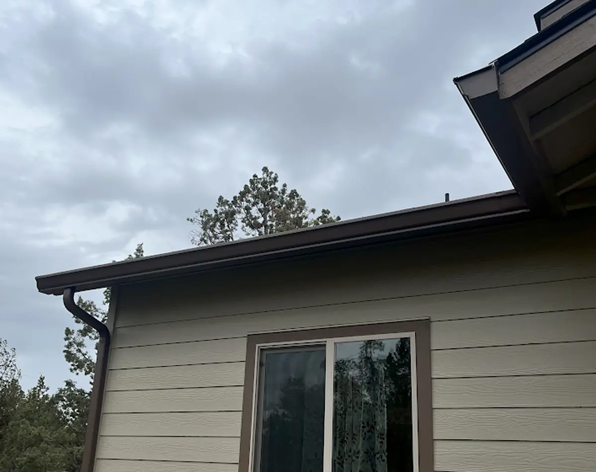 Brown gutter and window on house.